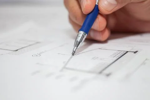 Construction engineer draws pencil Stock Photos