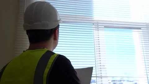 A construction engineer foreman oversees the project and writes down the plan Stock Footage 152828973