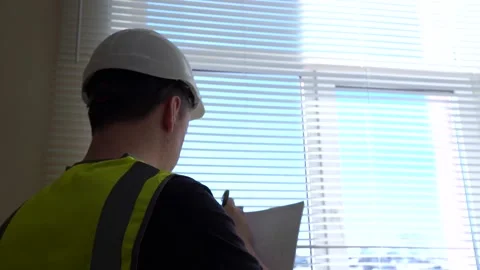 A construction engineer foreman oversees the project and writes down the plan Vídeo Stock 166053000