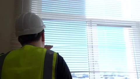 A construction engineer foreman oversees the project and writes down the plan Stock Footage 166226925