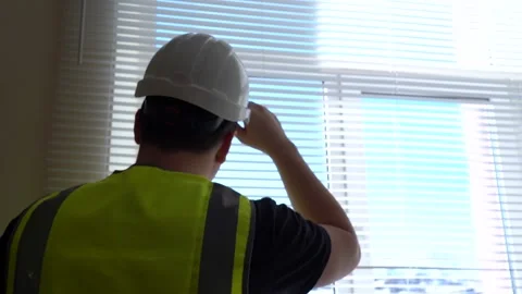 A construction engineer foreman oversees the project and writes down the plan Stock Footage 166996058