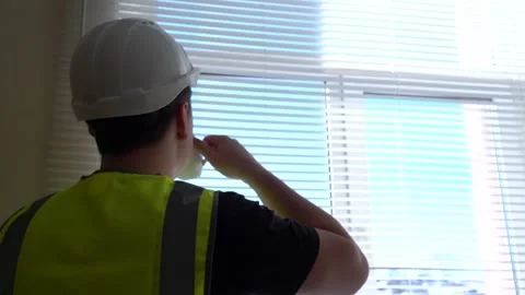 A construction engineer foreman oversees the project and writes down the plan Stock Footage 167213461