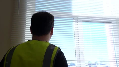 A construction engineer foreman oversees the project and writes down the plan Stock Footage 167692980