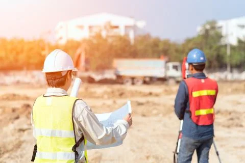 Construction engineer with foreman worker checking construction site Photos