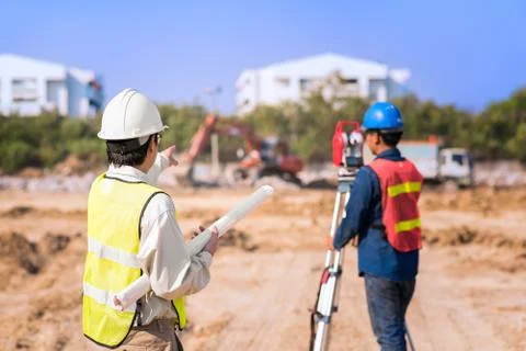 Construction engineer with foreman worker checking construction site Stock Photos