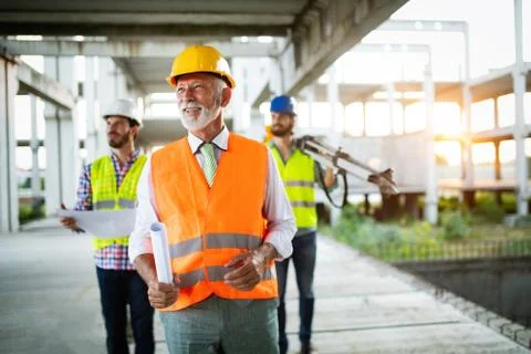 Construction engineer with foreman worker checking construction site Stock Photos