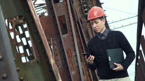 Construction engineer in helmet makes selfie on the phone Stock Footage 76201696