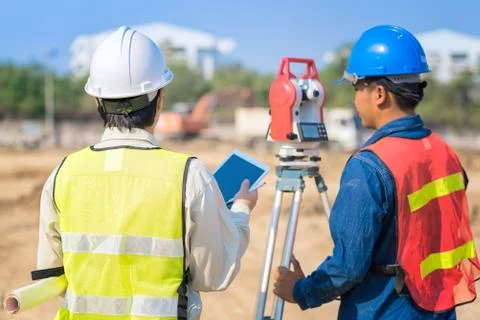 Construction engineer hodling construction drawing and smart tablet Photos