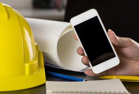Construction engineer is holding a blank smartphone screen Stock Photos