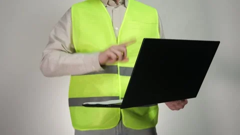 A construction engineer holds a laptop in his hands Stock Footage 311540808