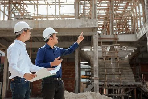 Construction engineer inspecting and working outdoors structure building si.. Stock Photos