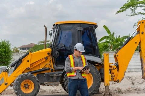 Construction Engineer Inspecting Excavator Stock Photos