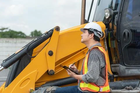 Construction Engineer Inspecting Heavy Machinery Stock Photos