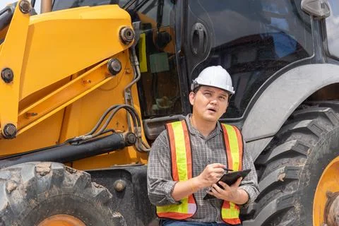 Construction Engineer Inspecting Heavy Machinery Stock Photos