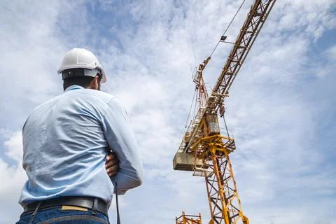 Construction engineer look at tower crane for Urban land development civili.. Stock Photos