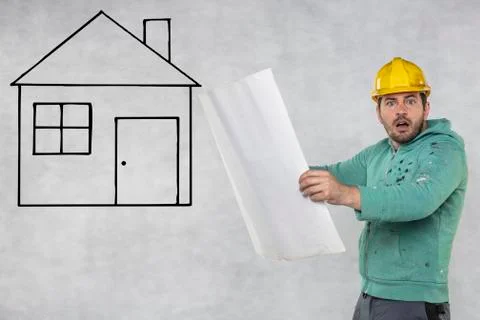 A construction engineer is looking at house plans Stock Photos