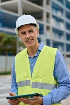Construction engineer managing building project with digital tablet Stock Photos