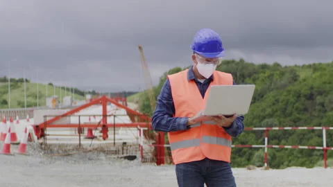 Construction engineer or an architect with a halmet and protective mask and e Stock Footage 133508314