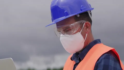 Construction engineer or an architect with a halmet and protective mask on a  Stock Footage 133512297