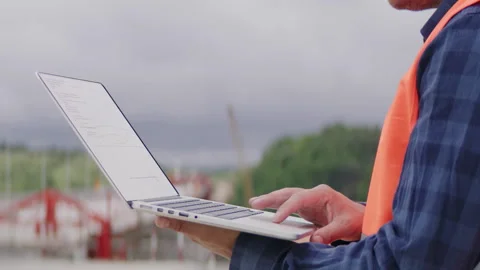 Construction engineer or an architect using a computer on a construction site Stock Footage 133502307