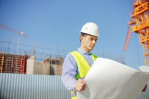 Construction engineer or architects student with drawing at construction site Stock Photos