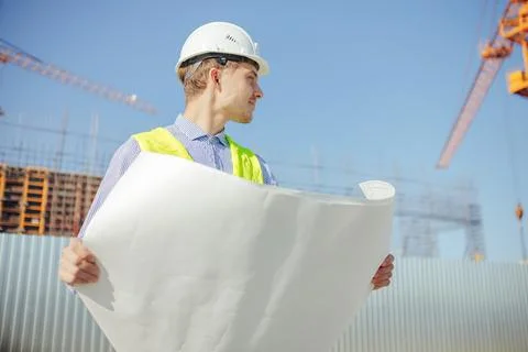 Construction engineer or architects student with drawing at construction site Stock Photos
