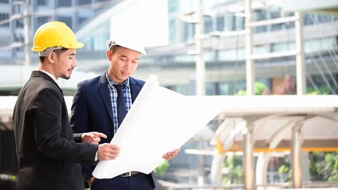 Construction engineer in Safety Suit Trust Team Holding White Yellow Safety hard Stock Footage 123359751