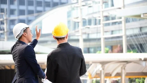 Construction engineer in Safety Suit Trust Team Holding White Yellow Safety hard Stock-Footage 123360311