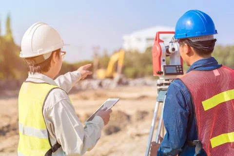 Construction engineer with smart tablet and foreman worker Photos