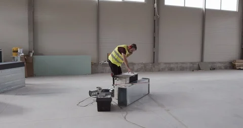 The construction engineer speaks on the phone and checks the plan of the works. Stock Footage 126910688