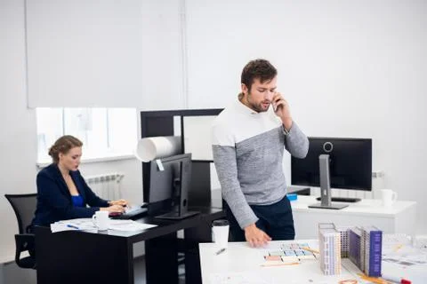 A construction engineer is talking over the phone with someone, Stock Photos