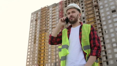 Construction engineer talking on the phone, discussing project details Stock Footage 128287688