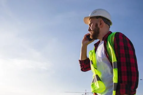 Construction engineer talking on the phone, discussing project details Photos