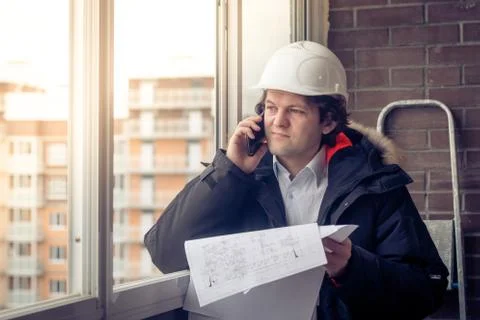 Construction Engineer Using Cell Mobile Phone. Soft focus, toned. Stock Photos