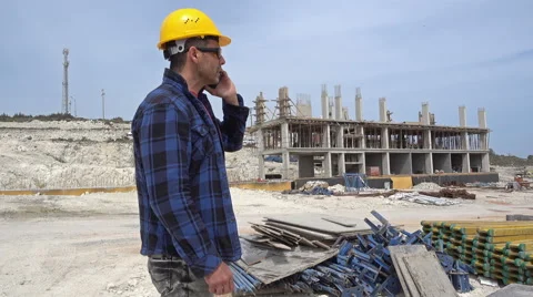 Construction Engineer  wearing helmets  and talking on the cellphone. Stock Footage 63052057
