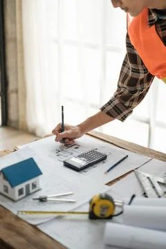 Construction engineer working at blueprint to build a home. Stock Photos