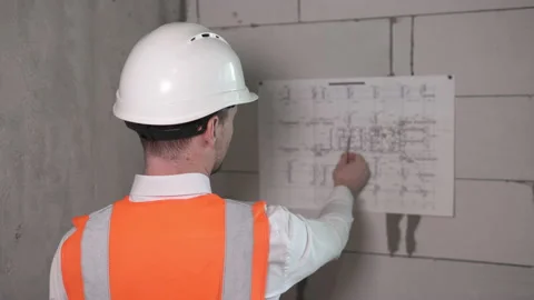 Construction engineer working with blueprints at a construction site Stock-Footage 154237140
