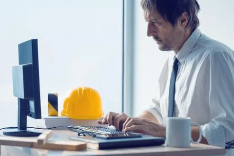 Construction engineer working on desktop computer using CAD soft Stock Photos