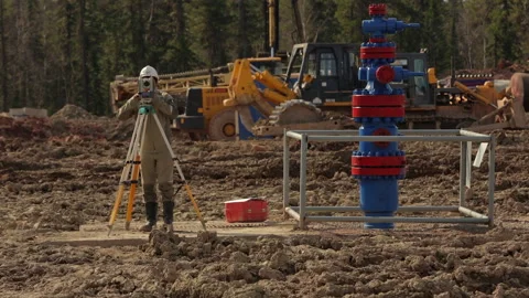 Construction engineer working with a theodolite Stock Footage 246752338
