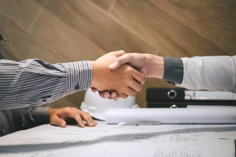 Construction engineering or architect discuss a blueprint while checking info Foto stock