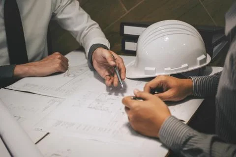 Construction engineering or architect discuss a blueprint while checking info Foto stock