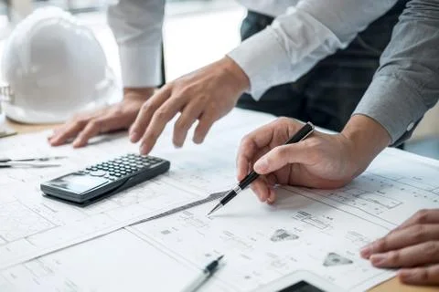 Construction engineering or architect discussing a blueprint and building mod Stock Photos