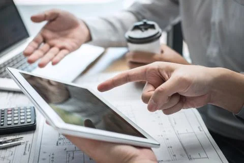 Construction engineering or architect discussing a blueprint and building mod Stock Photos