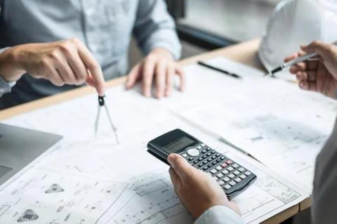 Construction engineering or architect discussing a blueprint and building mod Stock Photos