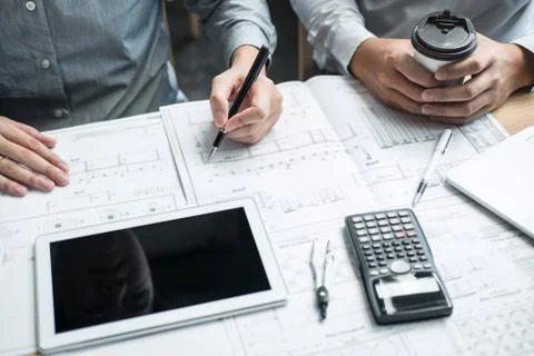 Construction engineering or architect discussing a blueprint and building mod Stock Photos