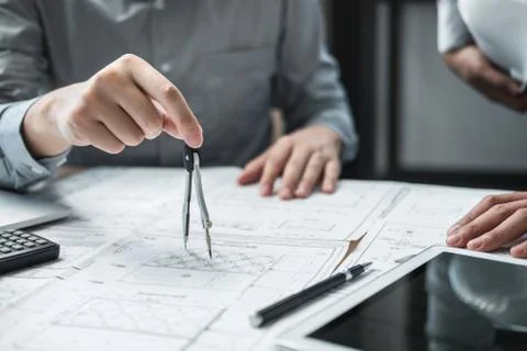 Construction engineering or architect discussing a blueprint and building mod Stock Photos