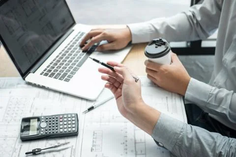 Construction engineering or architect discussing a blueprint and building mod Stock Photos