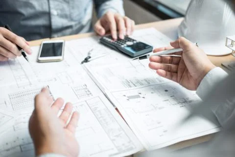 Construction engineering or architect discussing a blueprint and building mod Stock Photos