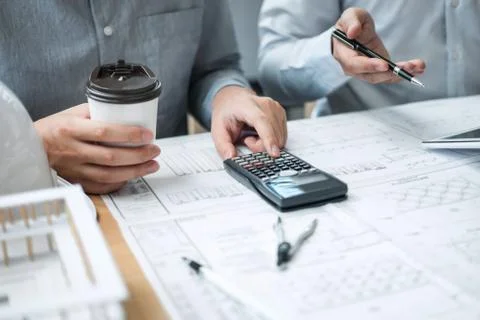 Construction engineering or architect discussing a blueprint and building mod Stock Photos