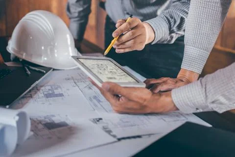 Construction engineering or architect discussing a blueprint and building mod Stock Photos